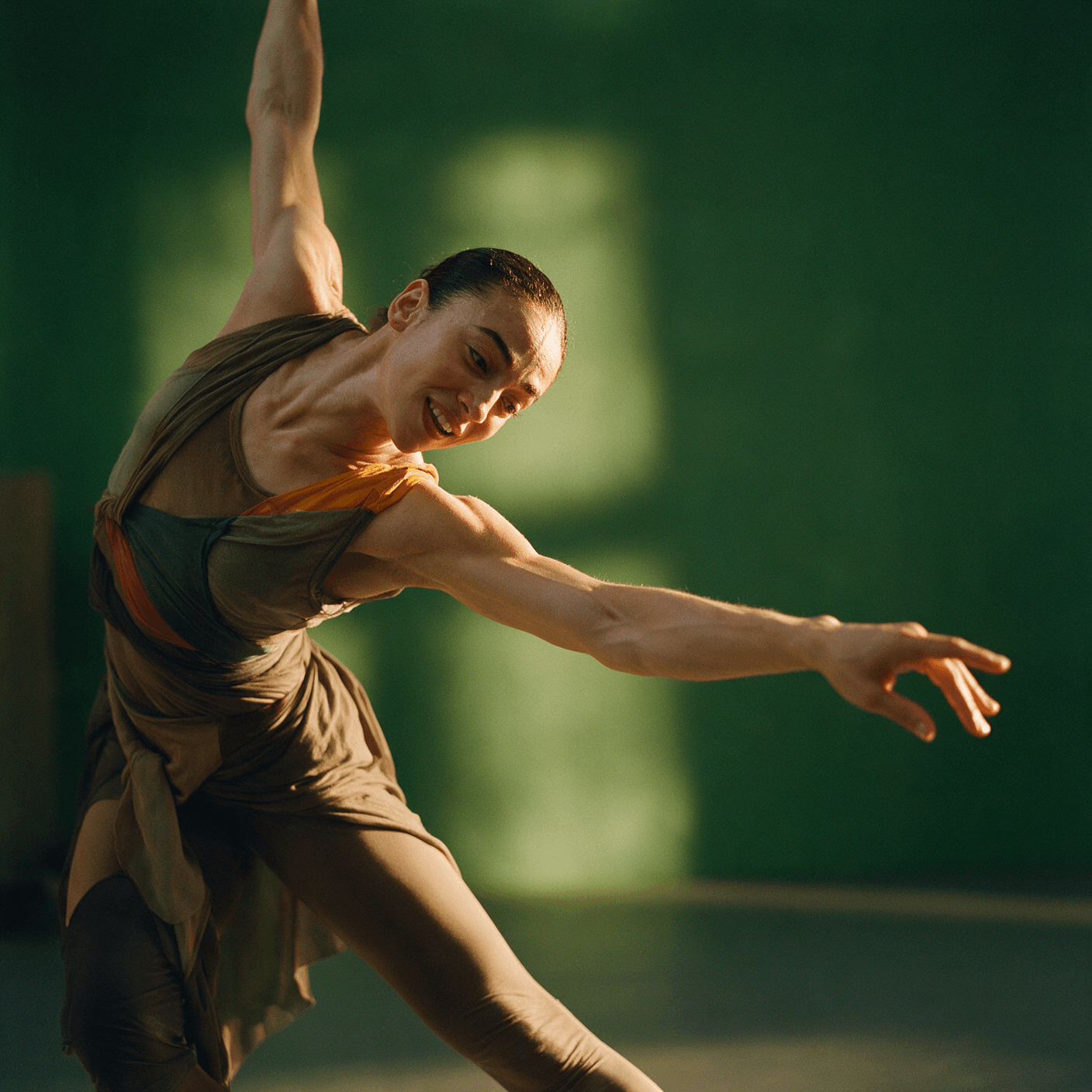 Editorial portrait of a dancer mid-stretch against a green studio wall generated with Seedream 5 Pro in Made