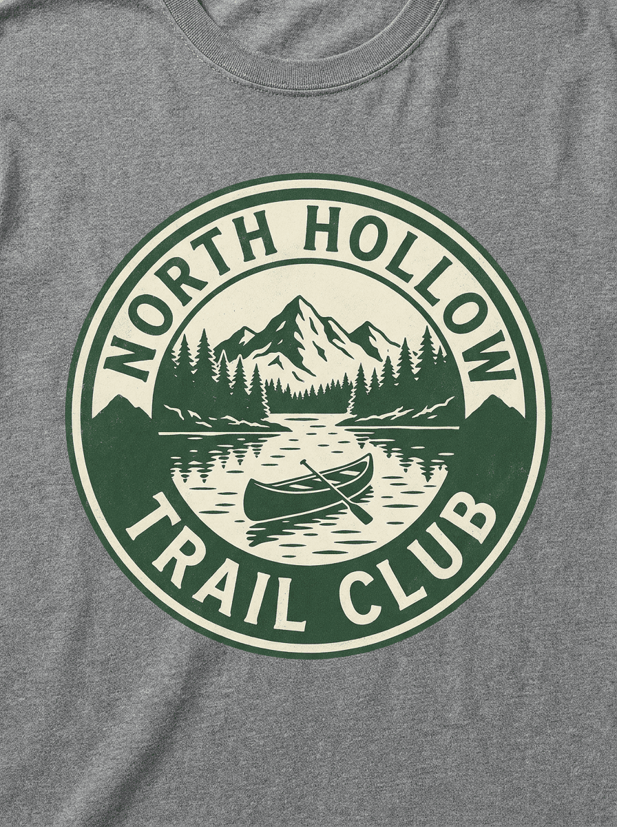 Circular outdoor badge t-shirt design with a lake, canoe, and treeline in two colors