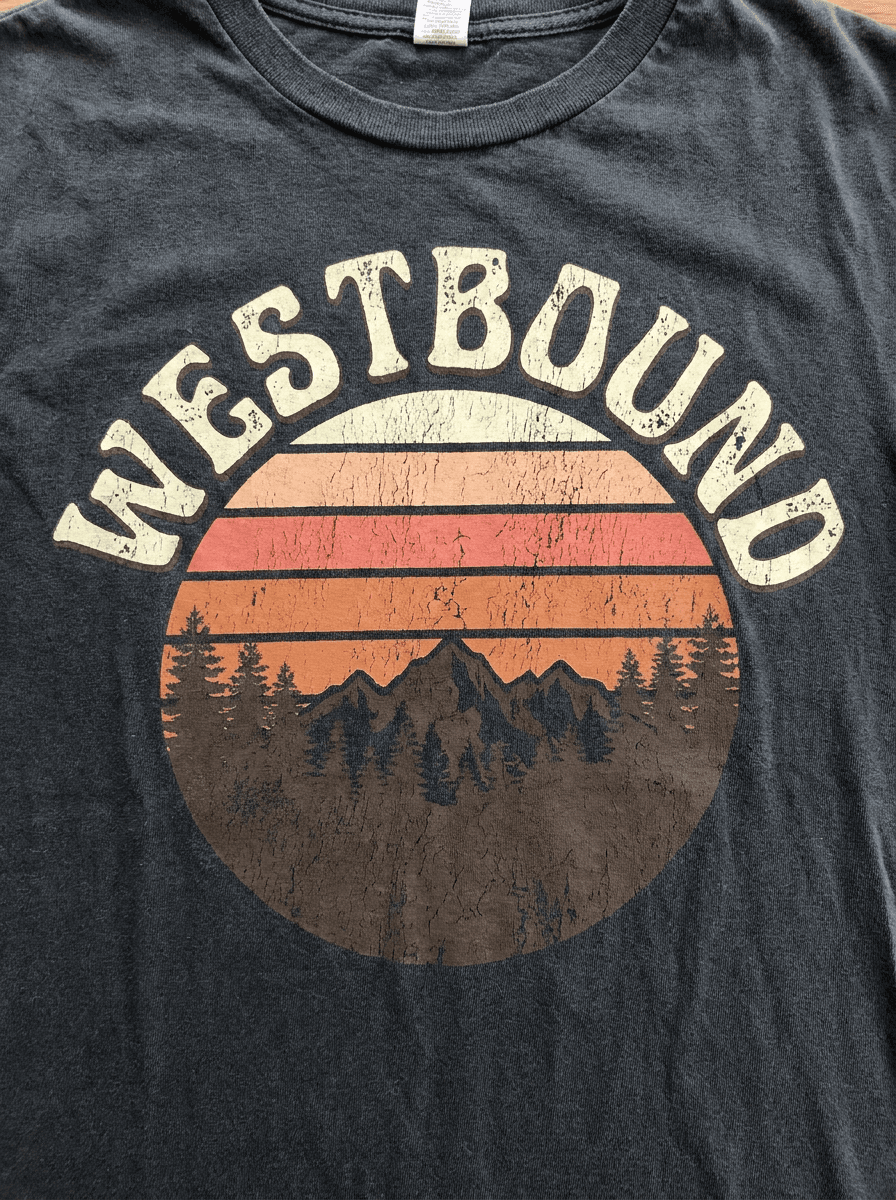 Retro striped sunset t-shirt graphic with arched seventies lettering on a dark background